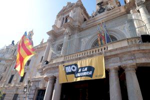 El Ayuntamiento de València cuelga en el balcón municipal una pancarta con el lema “No a la guerra”