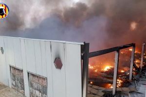 Controlado el incendio de una nave industrial llena de palets en Oliva